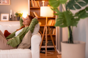 Serene woman relaxing on sofa, enjoying peaceful moment at home