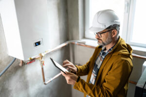 Technician Inspecting Gas Heating System with Digital Tablet in a Modern Setting Technician Inspecting Gas Heating System with Digital Tablet in a Modern Setting